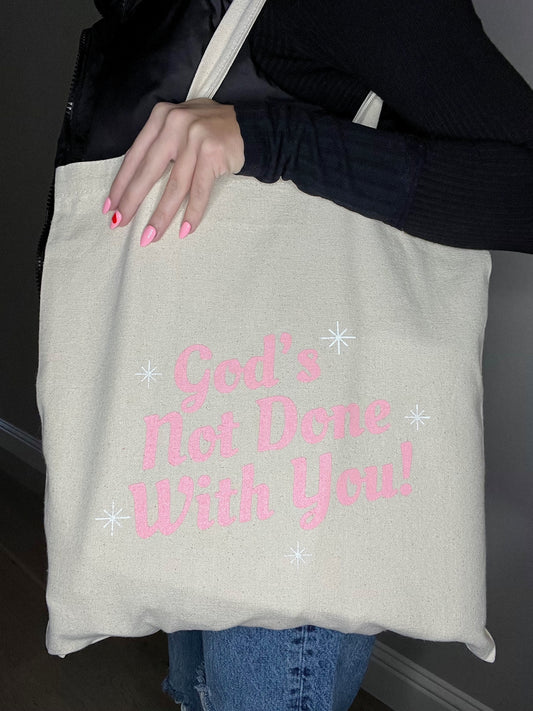 God's Not Done Tote Bag