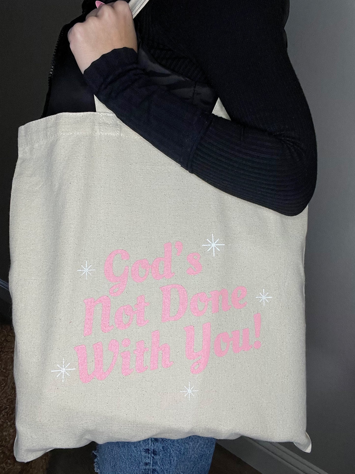 God's Not Done Tote Bag